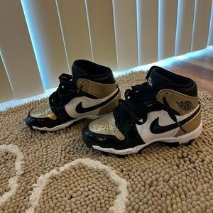 Nike Kids Black, White, and Gold Cleats